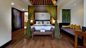 A bedroom with a wooden ceiling, a large bed with green curtains, a bench, and a sofa with pillows. - The Khayangan Dreams Villa Seminyak  (Seminyak)