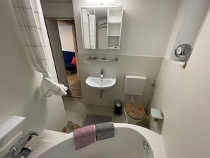 Bathtub, hair dryer, towels