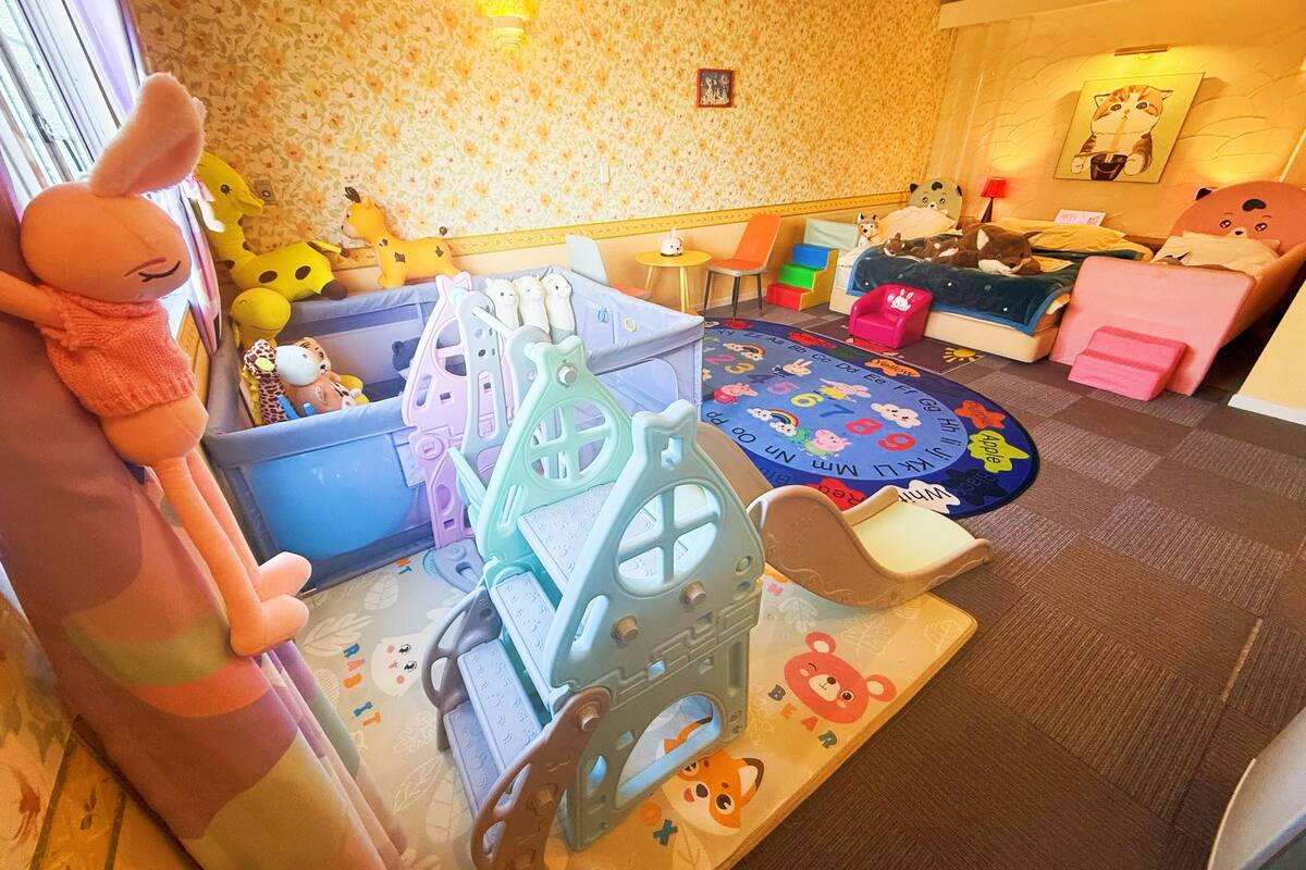 A children's play area with a variety of toys and play structures.