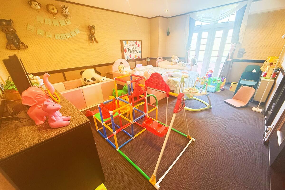 A child's play area with toys and a play structure.