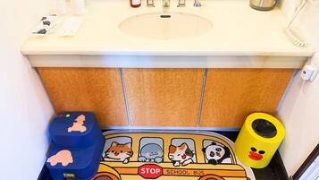 A bathroom with a sink, mirror, and toiletries.