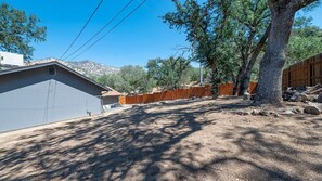 A residential area with a house, a fenced yard, and a large tree. - The Big Dipper between Kaweah River & Skyline, SNP (Three Rivers)