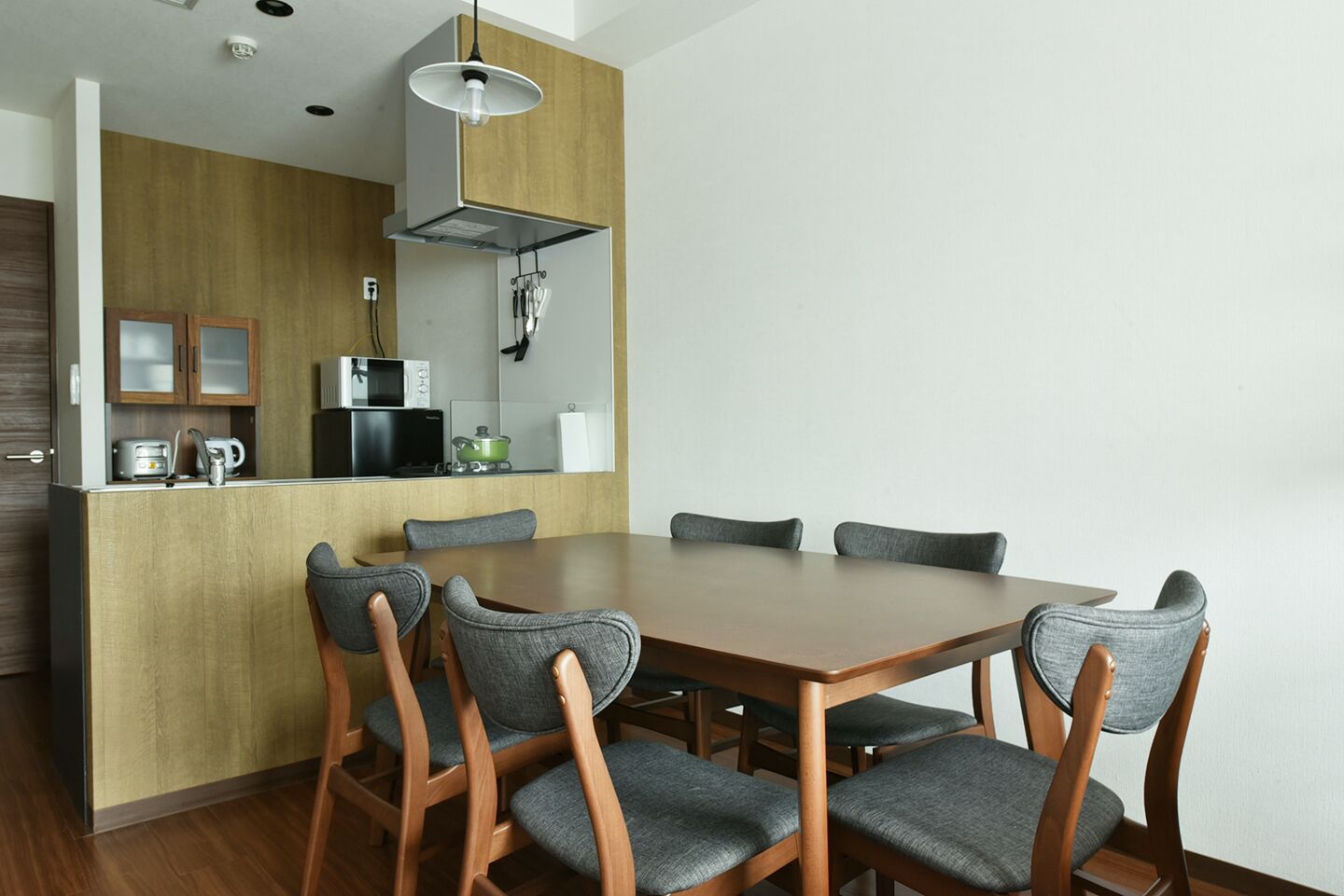 A compact kitchen with a dining area.