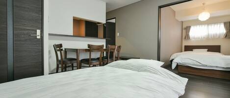 A hotel room with a bed, a desk, and a chair.