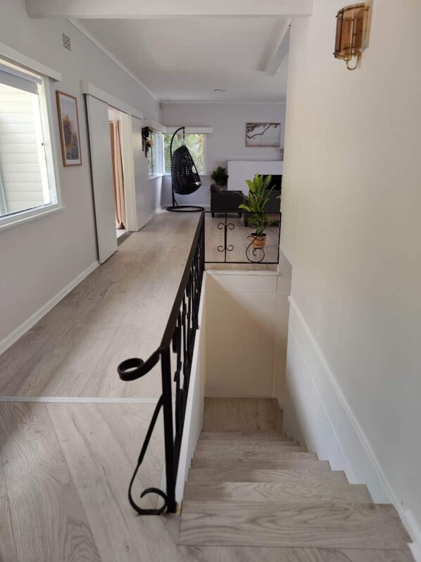 A staircase with a wooden floor leading to a landing.