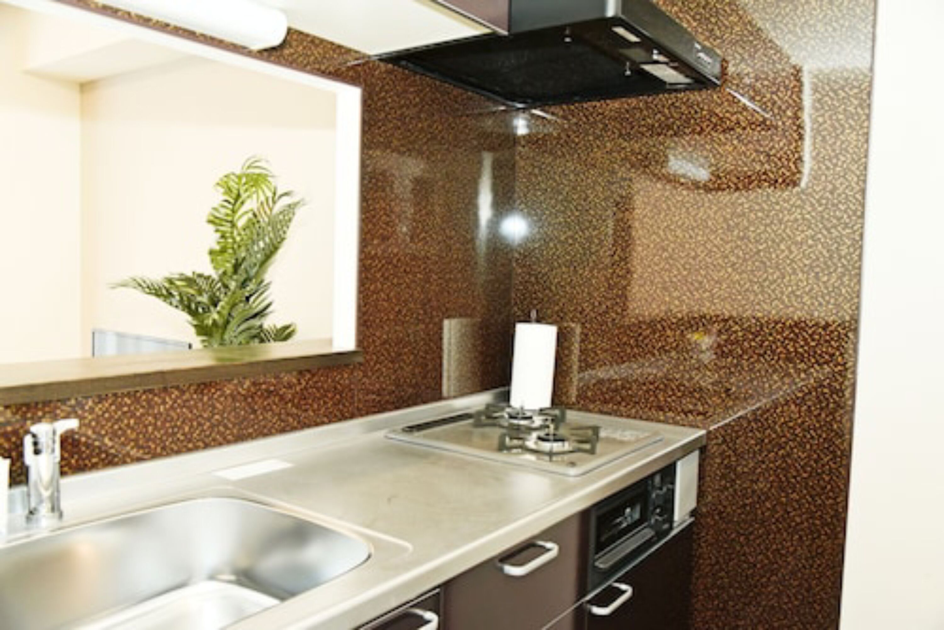 A modern kitchen with granite countertops, stainless steel appliances, and a built-in oven.