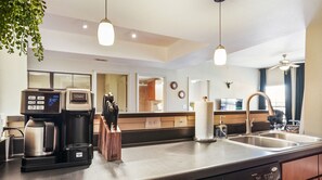 Enjoy cooking in this well-equipped kitchen with a coffee maker, knife block, and sink.