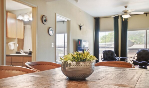 Enjoy meals in this cozy dining area with a wooden table and comfortable seating for four.