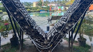 A heart-shaped sculpture made of stacked pipes in an outdoor setting. - AT Hotels & Resorts (Port Blair)