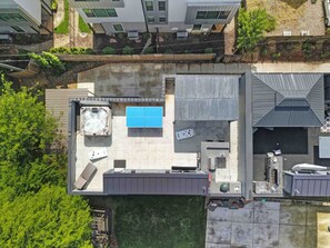 An aerial view of a rooftop with a swimming pool, outdoor seating, and a small garden area. - 906 Westbrook B  · City Views RoofTop & Short Walk to Stadium (Charlotte)