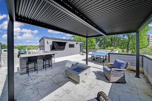 An outdoor patio with a barbecue area, seating, and a pool. - 906 Westbrook B  · City Views RoofTop & Short Walk to Stadium (Charlotte)