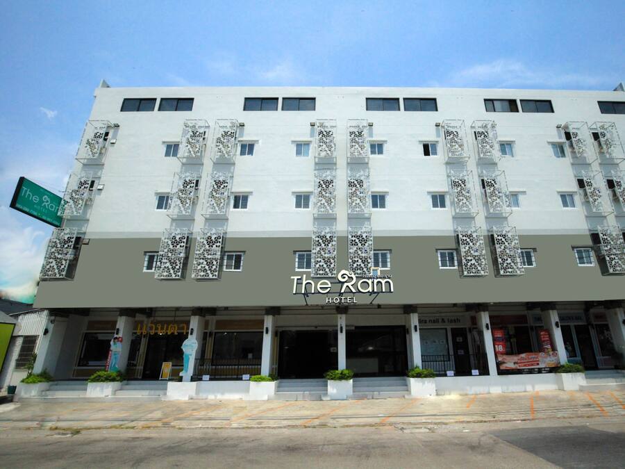 A hotel named "The Ram" with a modern facade, multiple balconies, and a prominent entrance.