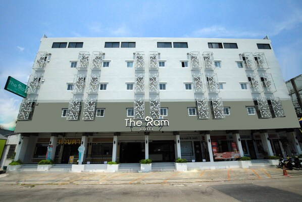 A hotel named "The Ram" with a modern facade, multiple balconies, and a prominent entrance. - The Ram Hotel  (Bangkok)