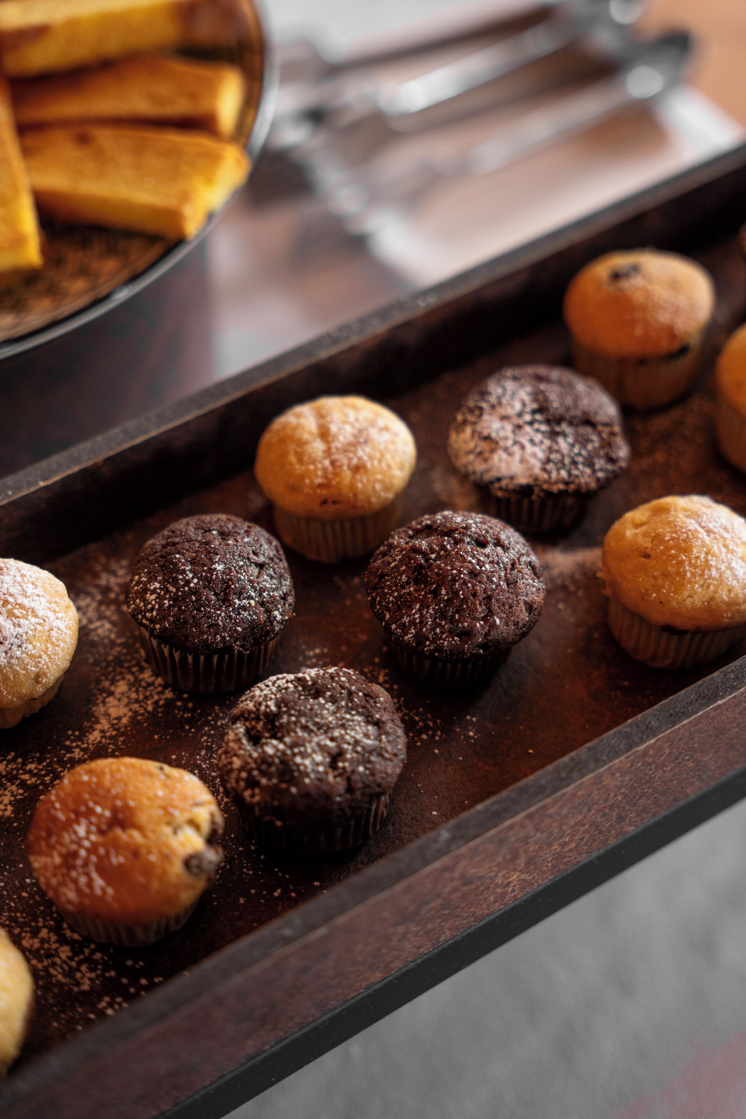 A tray of muffins on a dark surface.