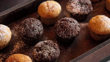 A tray of muffins on a dark surface.