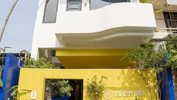 A modern building with a white upper level and a yellow lower level.