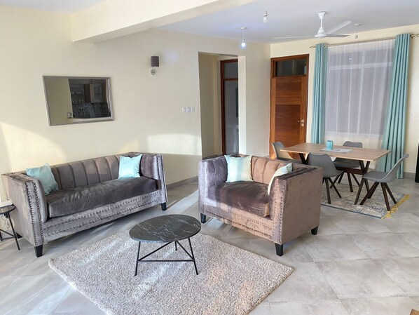 Deluxe Apartment | Living area | 32-inch flat-screen TV with digital channels, TV