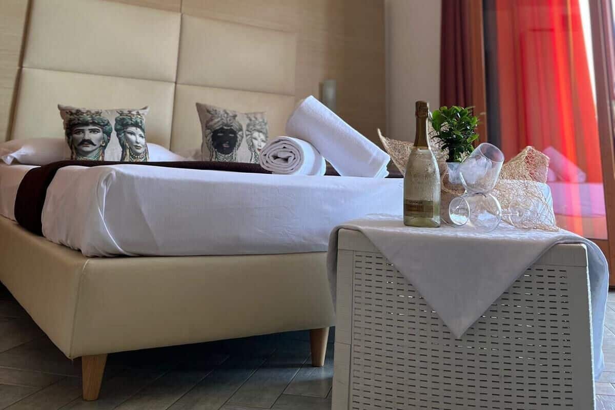 Deluxe Quadruple Room | Minibar, in-room safe, desk, blackout drapes