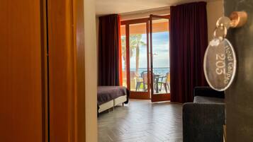 Deluxe Quadruple Room | Minibar, in-room safe, desk, blackout curtains