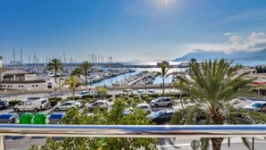 A marina with boats, a clear sky, and a mountain in the background.