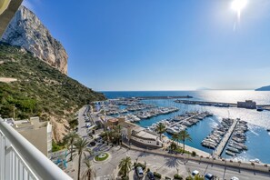 A coastal marina with boats docked, a clear sky, and a mountainous backdrop. - NAUTICO, Apartment for rent in Calpe for 4 pax with swimming pool and private parking (Calpe)