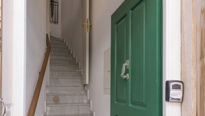 A staircase leading to a green door with a keypad lock. - Rethymno Heart (Rethymno)