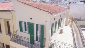 A multi-story building with balconies, a ground-floor shop, and a red-tiled roof. - Rethymno Heart (Rethymno)