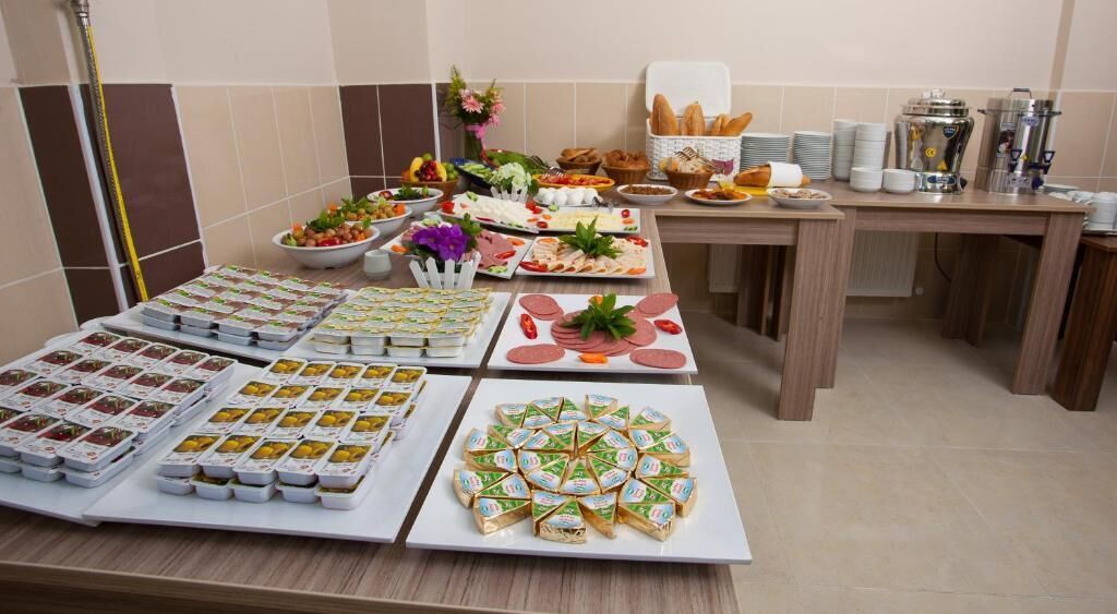 A buffet table with various food items and a coffee station.