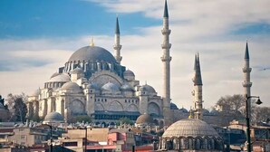 Una gran mezquita con cúpulas y minaretes múltiples, rodeada de edificios urbanos.