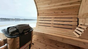 A wooden cabin with a view of a frozen lake.