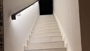 A staircase with light-colored steps and a handrail on the left, leading to a dark area at the top. - LUXURY WELLNESS PENTHOUSE KADENA WITH DREAM SEE VIEW (Zadar)