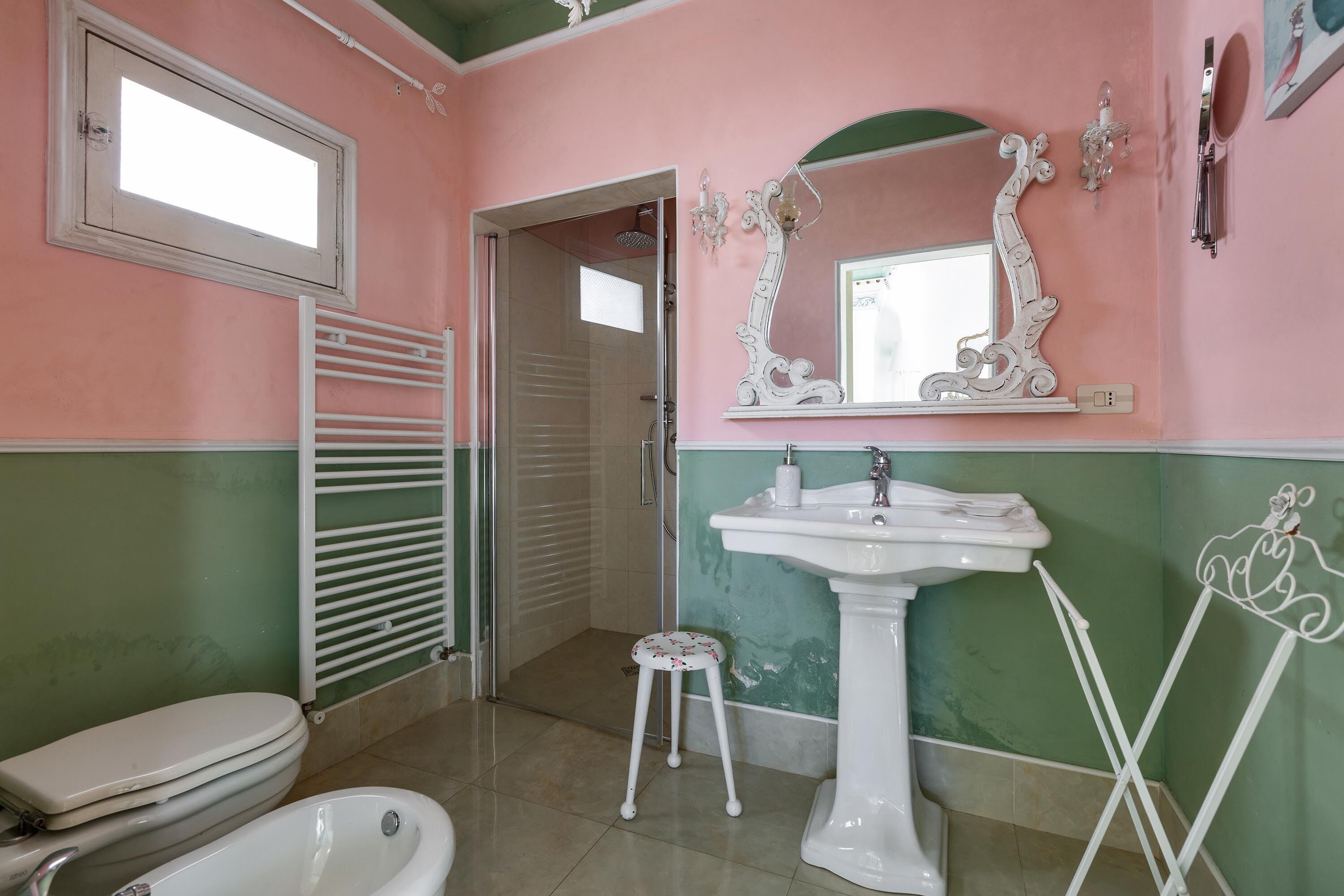 A bathroom with a toilet, sink, and shower.