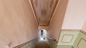 A staircase with a handrail, leading to a doorway at the top.