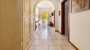A hallway with a tiled floor, a door at the end, and a framed picture on the wall. - 3266 Villetta Delle Viole by Barbarhouse (Torricella)