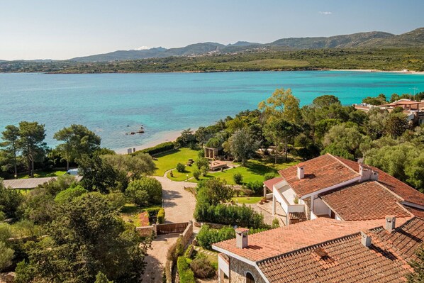A coastal property with a view of the sea, terraced gardens, and traditional architecture. - Villa Il Mosaico di Nora- Sardinia Unlimited (Porto Istana)