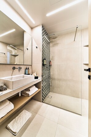 Shower, designer toiletries, hair dryer, bathrobes
