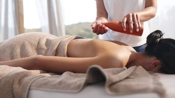 Experience a soothing massage in a serene setting with a view of the surrounding landscape.
