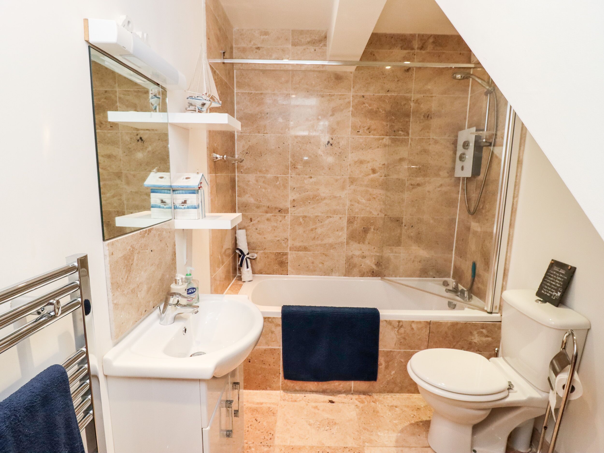 A modern bathroom with a bathtub, toilet, and sink.