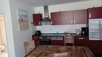 Fridge, stovetop, dishwasher, coffee/tea maker