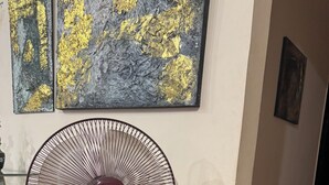 A standing fan, a wall socket, and a patterned carpet. - Jamila basement apartment (New Cairo)