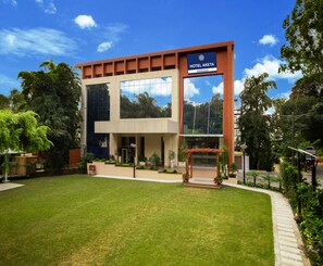 A modern hotel building with a prominent sign reading "HOTEL AKETA DEHRADUN". - Hotel Aketa Rajpur Road Dehradun, Dehradun (Dehradun)
