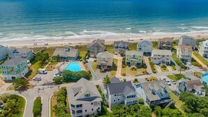 A coastal residential area with houses, a swimming pool, and a beach. - Sea La Vie | Oceanfront + Community Pool! (North Topsail Beach)