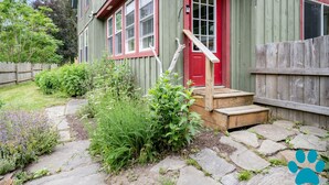 A house with a red door, a wooden staircase, and a stone pathway leading to the entrance. - Minutes to Canandaigua Lake Boat Launch, Fireplace, Large Yard, Hiking (Naples)