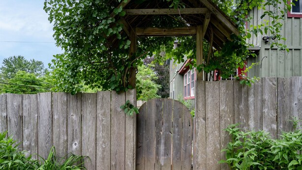 A wooden gate with a wooden structure above it, surrounded by greenery and a stone pathway. - Minutes to Canandaigua Lake Boat Launch, Fireplace, Large Yard, Hiking (Naples)
