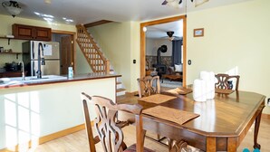A spacious kitchen with wooden cabinets, a stainless steel refrigerator, and a wooden island with a sink. - Minutes to Canandaigua Lake Boat Launch, Fireplace, Large Yard, Hiking (Naples)
