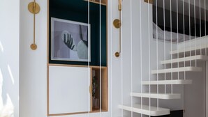 A modern staircase with white steps and a wooden finish, leading to a dark room. - ParisConciergerie - Design studio in Paris (Paris)