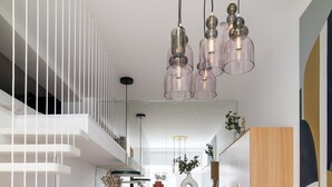 A modern kitchen with white cabinets, a wooden countertop, and a hanging light fixture. - ParisConciergerie - Design studio in Paris (Paris)