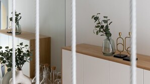 A modern bathroom with a wooden vanity, a mirror, and a shelf with decorative items. - ParisConciergerie - Design studio in Paris (Paris)