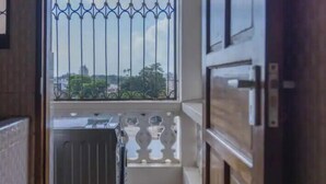 A narrow corridor with a metal gate leading to a balcony. - Divine apartments (Mombasa)