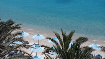 On the beach, sun-loungers, beach umbrellas, beach bar